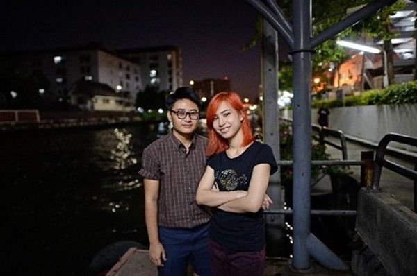 Chalit Pongpitakwiset và bạn gái đứng đợi tàu trên một bến tàu ở Bangkok. Ảnh: AFP